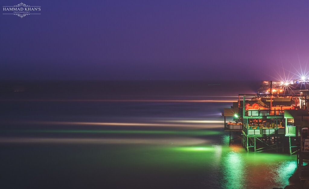 Seaside restaurants lit up at night at Do Darya, Karachi