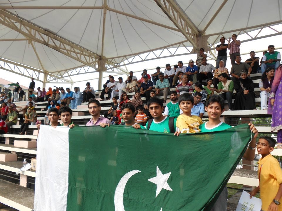 Pakistan fans waving the national flag at a hockey tournament